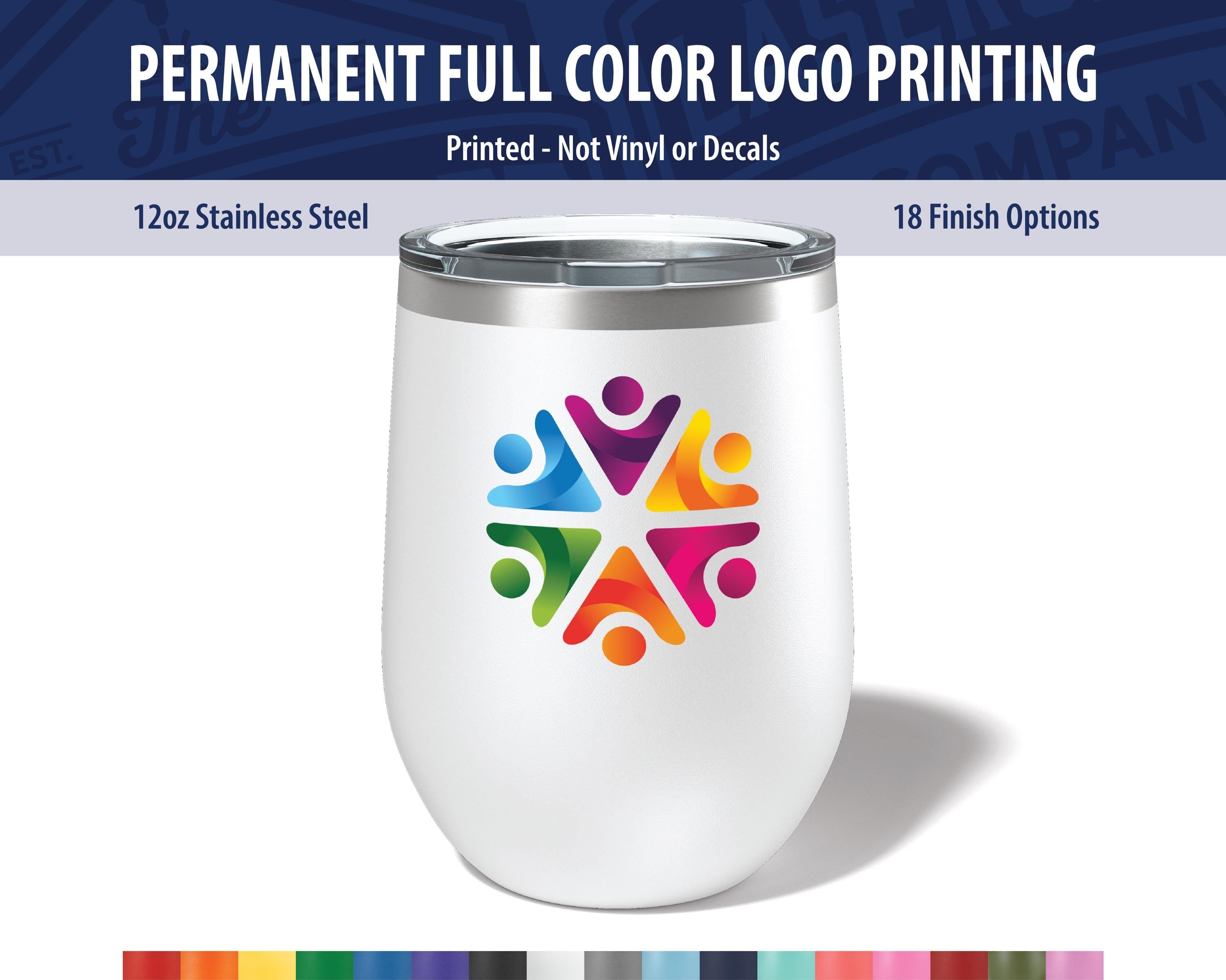 a white ceramic mug with a colorful logo printed on it. The mug has a 12 oz stainless steel body and a lid with a silver rim. The logo is a vibrant design of people holding hands. The mug is presented against a white background, and there are 18 finish options available for customization.
